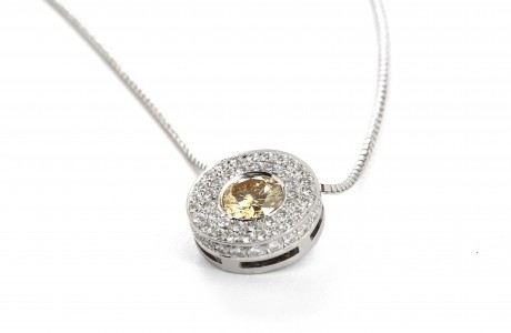 Round golden pendant set with diamonds and a precious stone